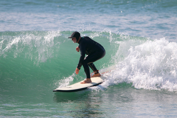 A surfer rides the waves at Endless Summer Surf Camp